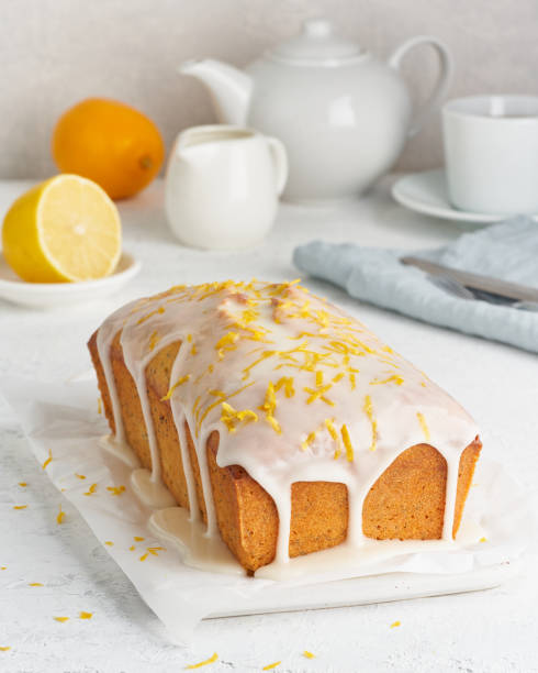 istock Lemon bread coated with sugar sweet. Cake with citrus, Whole loaf, side view, close up, vertical 1206200225