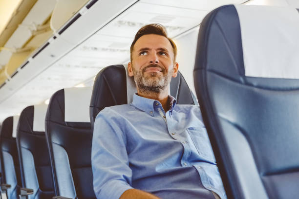 istock Businessman sitting in the airplane 1206200939