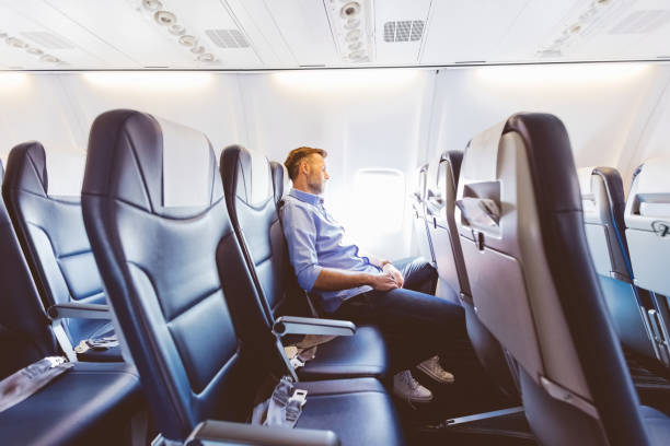 istock Male passenger napping in the airplane 1206201828