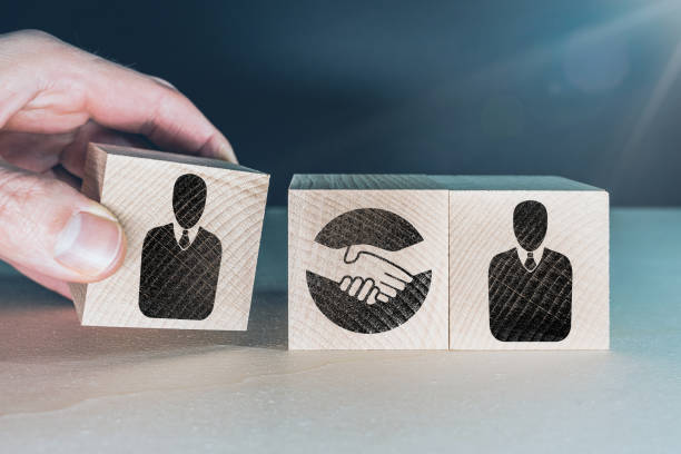 istock businesss agreement or cooperation concept with wooden blocks 1206202552