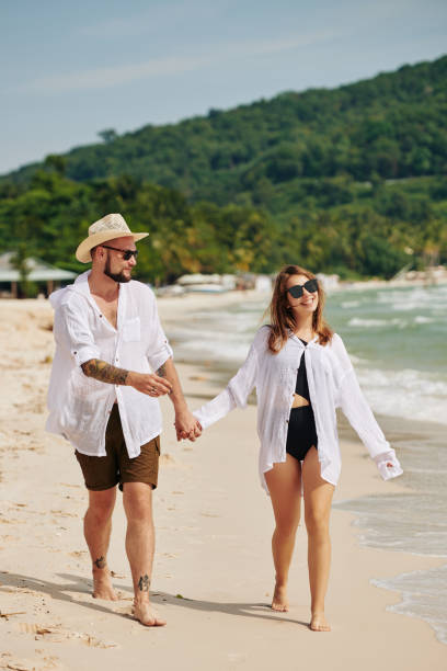istock Couple walking on the beach 1206204768