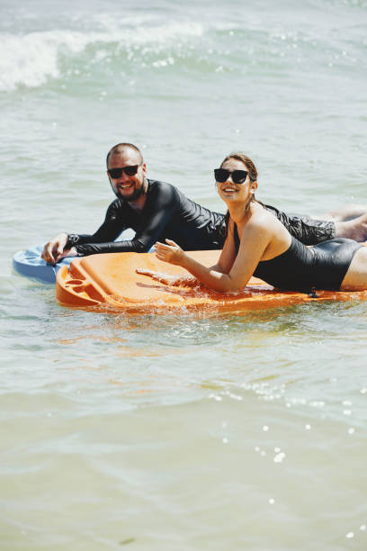 istock Couple swimming on mattresses 1206204915