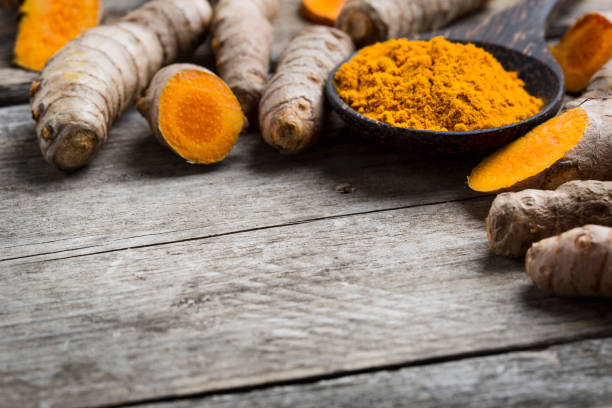 istock Curcuma longa, turmeric, powder and rhizomes - copy space 1206206474