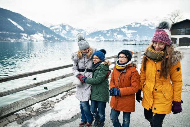 Family walking by Zell am See lake, Austria