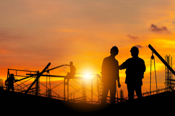 istock Silhouette of Engineer and worker with clipping path on building site, construction site at sunset in evening time. 1206213465