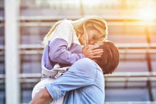 Photo of Attractive boy and girl hugging and kissing.