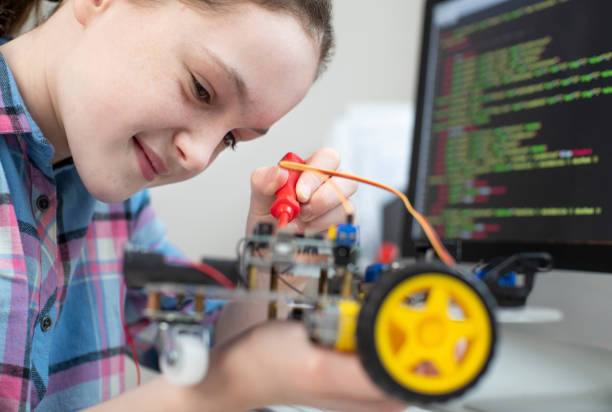 istock Female Pupil Building Robotic Car In Science Lesson 1206218671