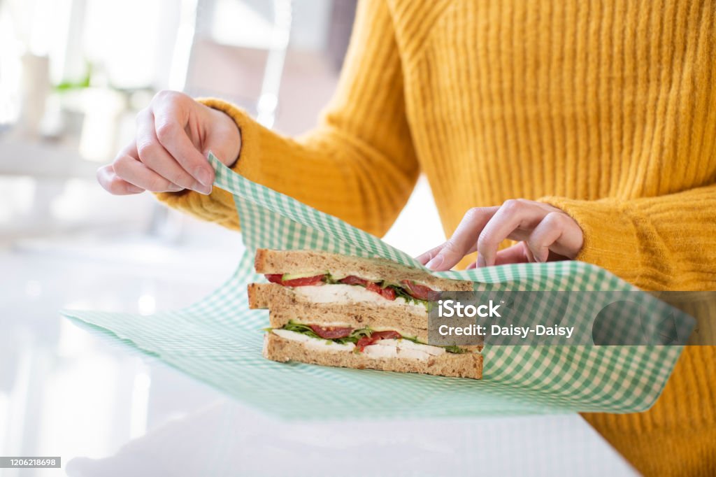 Close Up Of Woman Wrapping Sandwich In Reusable Environmentally Friendly Beeswax Wrap Beeswax Wrap Stock Photo