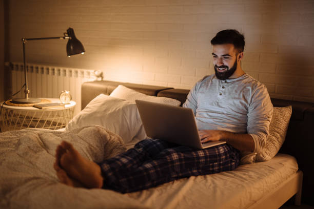 istock Young man working late in bed on a laptop 1206218718