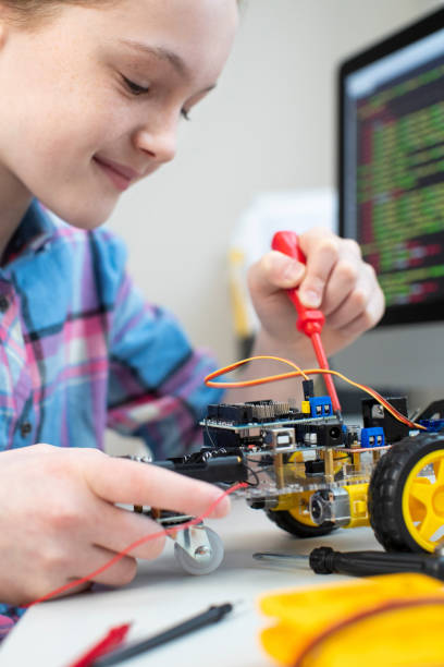 istock Female Pupil Building Robotic Car In Science Lesson 1206218796