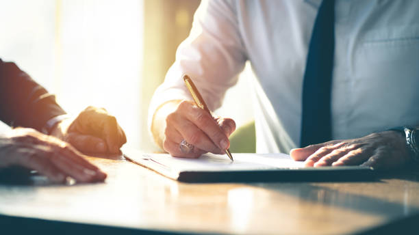 Business contract signing. Closeup Businessman signing a contract investment professional document agreement on the table with pen. endorsing stock pictures, royalty-free photos & images