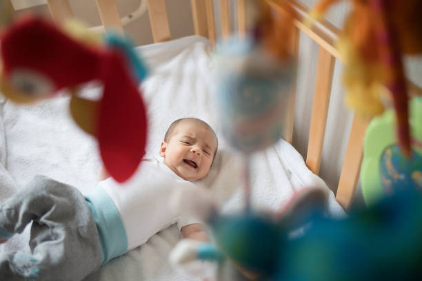 istock Crying baby in his bed. Newborn crying baby. 1206219920