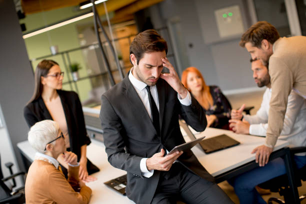 istock Worried young businessman using digital tablet in office 1206222074