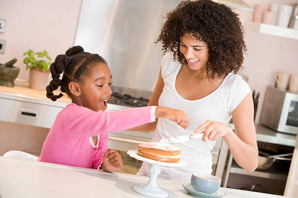 istock Mother and daughter enjoy icing a cake together 120622283