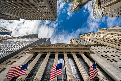 Financial district city buildings outside the New York Stock Exchange building on Wall Street \non October 10, 2019 in New York