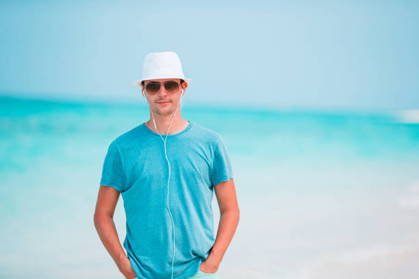 istock Young man on the white tropical beach 1206223983