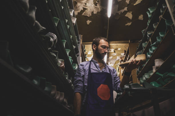 istock Cobbler in glasses at shoe form storage 1206224290