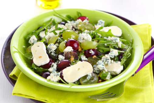 Fresh salad with variety of grapes and cheese, dressing with walnut
