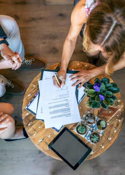 istock Top view of woman signing a document 1206225142