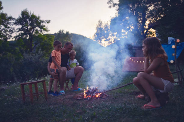 istock Father with children making a camping fire in the backyard. 1206225238