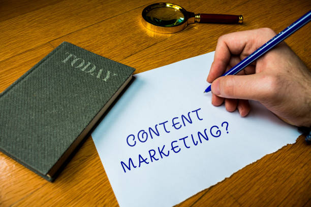 istock Conceptual hand writing showing Content Marketing question. Business photo text involves creation and sharing of online material Man writing document wood table magnifying glass electronic device. 1206225292