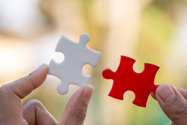 istock Hand connect white and red jigsaw parts with word problem & solution.   symbol of association and connection. business strategy. Teamwork concept. 1206225345