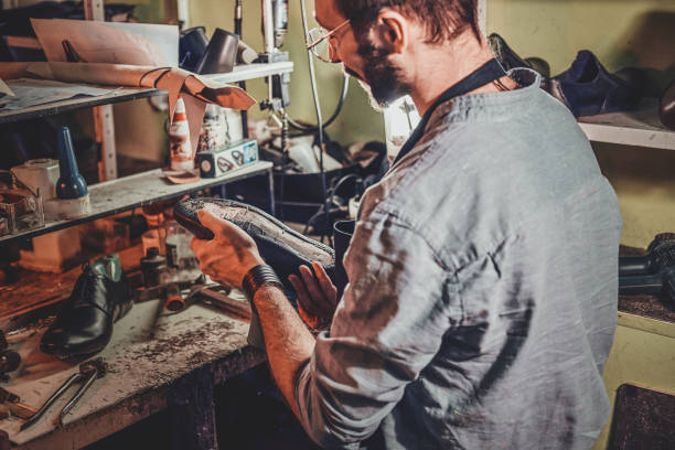 istock Cobbler is repairing shoes for customers 1206225603