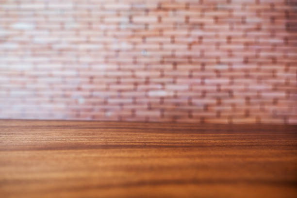 Closeup image of wooden table with blur brick wall background