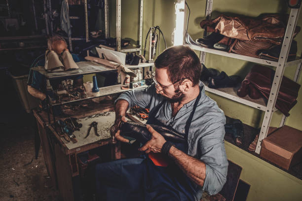 istock Cobbler is working on shoe sole 1206226115