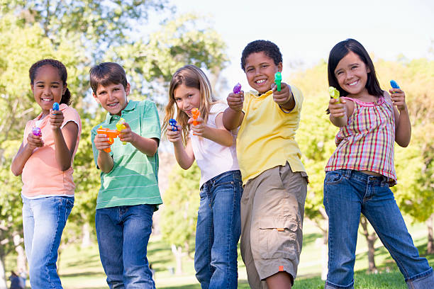 istock Five young friends with water guns outdoors smiling 120622675