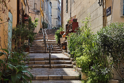 Stairway, a souvenir shop and historical houses in the old part of Marseille, France