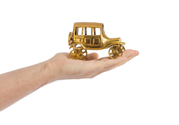 istock Hand and toy vintage car 1206227472