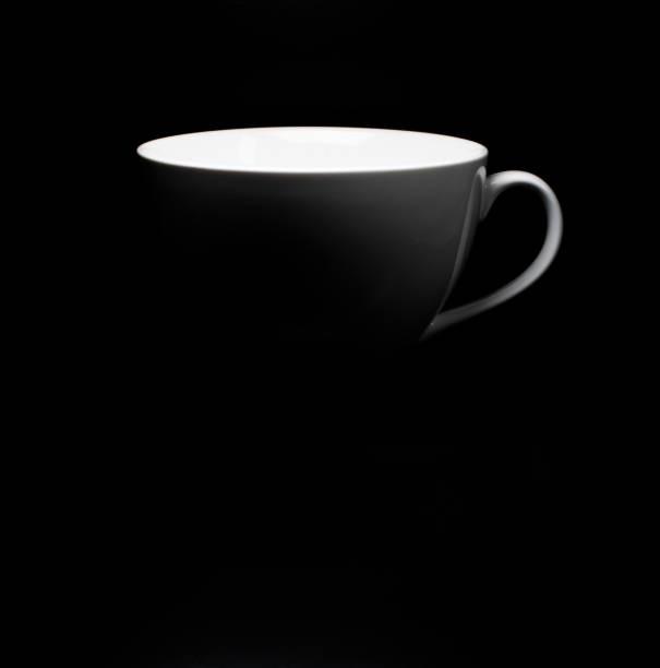 white porcelain cup on black background