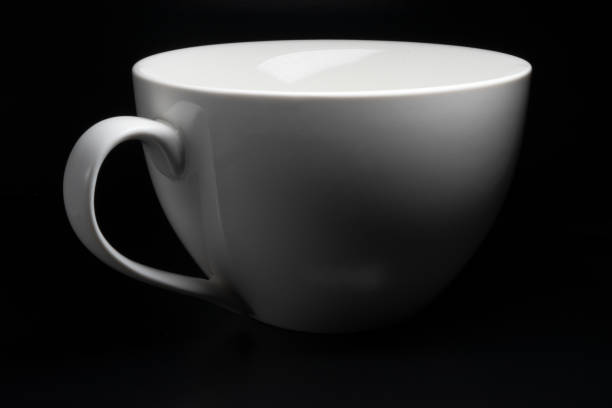 istock white porcelain cup on black background 1206228696