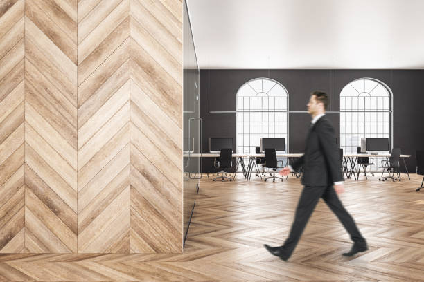 istock Businessman walking in wooden office 1206229588