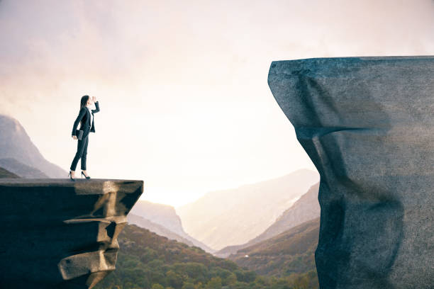 istock businesswoman in suit standing on mountain 1206232804