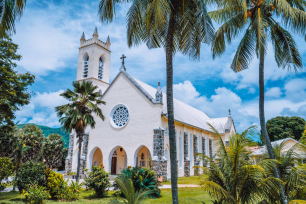 Mahe Island, Seychelles. St Roch Roman Catholic Church between palm trees near Beau Vallon location Mahe Island, Seychelles. St Roch Roman Catholic Church between palm trees near Beau Vallon location. mahe island stock pictures, royalty-free photos & images