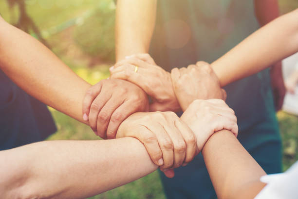 together collaborate of hands teamwork at park outdoor. Team Work charity Concept, Group of Diverse Hands Together Cross Processing of people in the nature