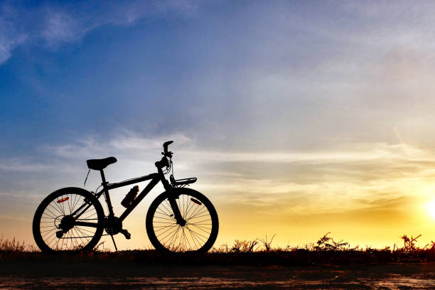 istock silhouete bicycle with beautiful sunset or sunrise sky 1206239217