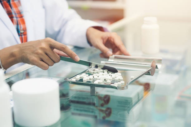 istock Medicine tablets on counting tray with counting spatula at pharmacy 1206239385