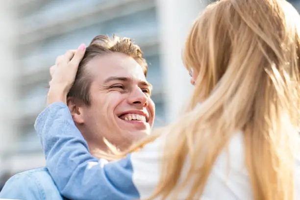 Photo of Attractive boy and girl hugging and kissing.