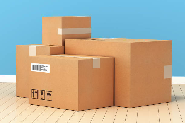 Cardboard boxes package delivery carton stock photo on tile background