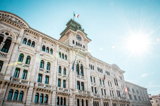 low angle view of town hall in trieste, italie - morning italy shadow sunlight photos et images de collection