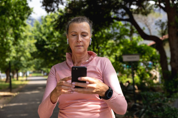 istock Female jogger using mobile phone in the park 1206244287