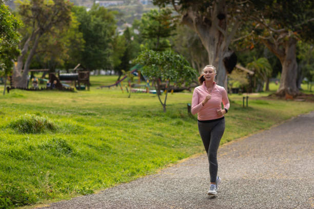 istock Female jogger running in the park 1206244362