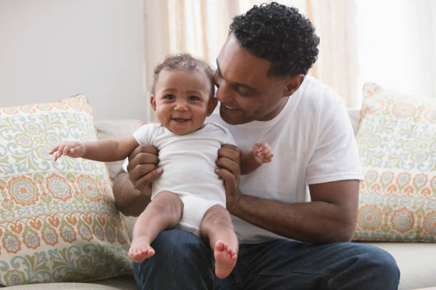 istock Father playing with his daughter sitting at the sofa 1206244421