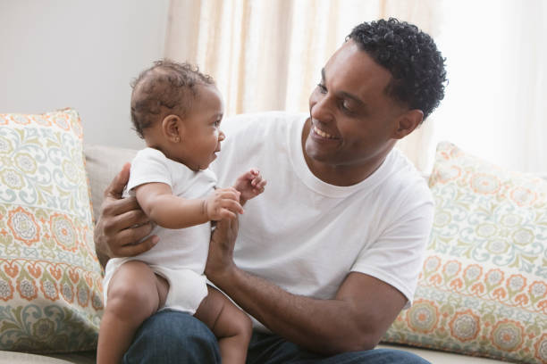 istock Father playing with his daughter sitting at the sofa 1206244446