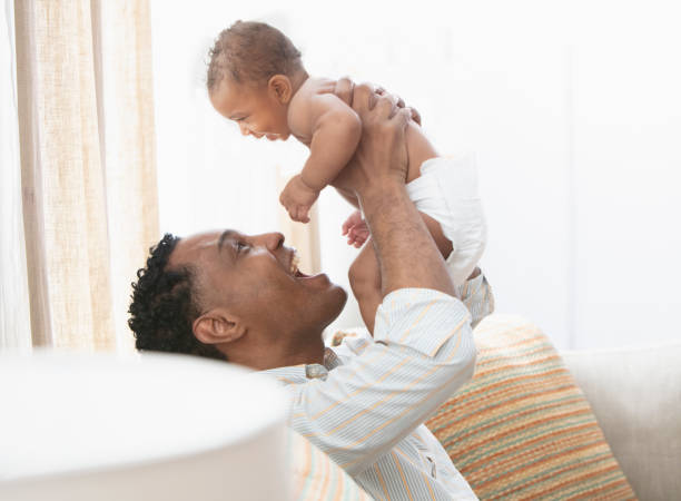 istock Father and daughter playing sitting at the sofa 1206244855