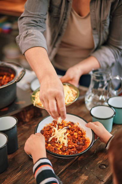 Young Family Eating Chili Con Carne