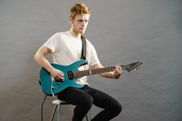 istock Young man playing electric guitar 1206248149